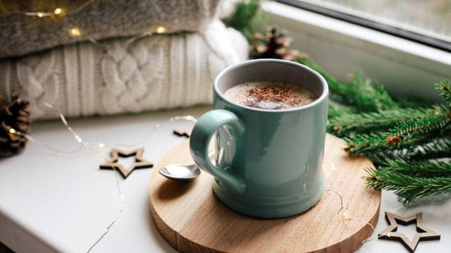 cup of hot chocolate on windowsill in winter